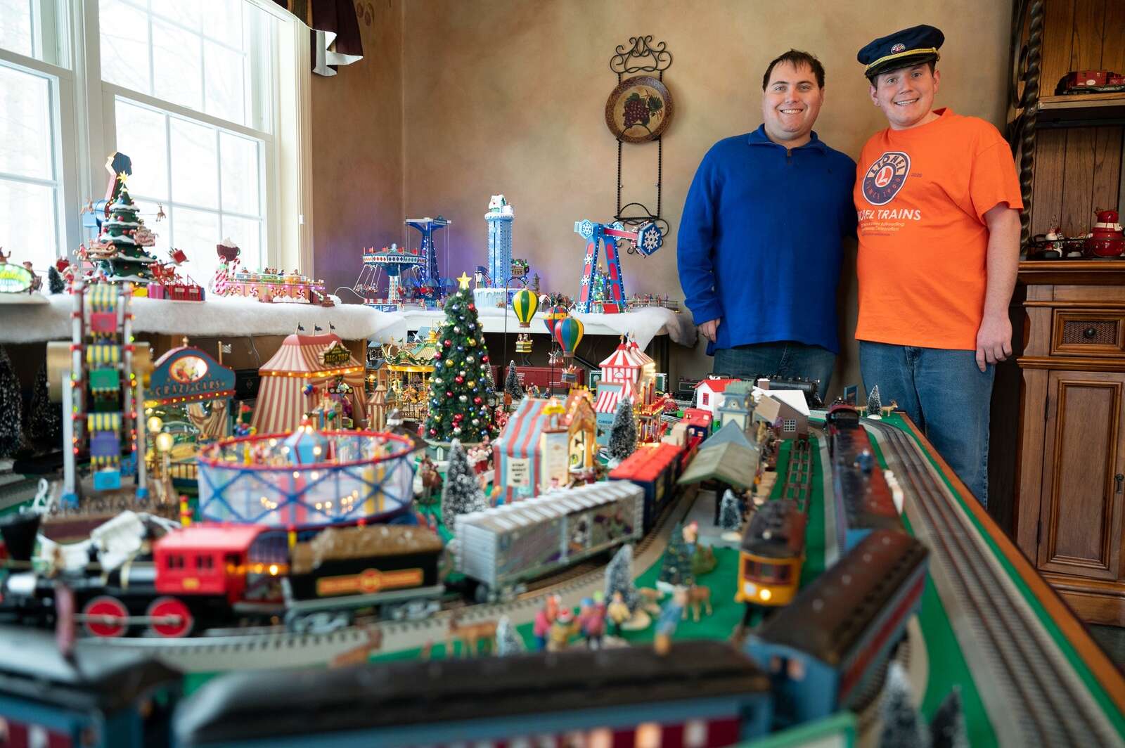 Lance and Bradley beside the family Christmas train layout